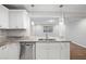 Modern kitchen featuring stainless steel dishwasher, granite countertops, and white cabinetry at 305 Winding River Village Dr # F, Atlanta, GA 30350