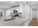 Bright kitchen featuring stainless steel appliances, granite countertops, and white cabinets at 305 Winding River Village Dr # F, Atlanta, GA 30350