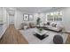 Living room with neutral paint, wood floors and a decorative area rug at 305 Winding River Village Dr # F, Atlanta, GA 30350