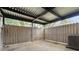 A fenced patio with concrete flooring and a metal covering at 305 Winding River Village Dr # F, Atlanta, GA 30350