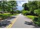 Residential street view with mature trees and well-maintained lawns leading to the property at 3443 Estes Dr, South Fulton, GA 30349