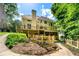 The home's exterior features a spacious deck, screened porch, and lush backyard with manicured landscaping at 5309 Ashley Trce, Atlanta, GA 30360