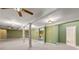 Finished basement featuring columns, neutral carpet, lots of lighting, and a doorway to an adjacent bathroom at 5309 Ashley Trce, Atlanta, GA 30360