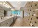 Expansive bathroom with dual sinks, a vanity area, granite countertops, and tile accents at 5309 Ashley Trce, Atlanta, GA 30360