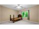 This light-filled bedroom includes carpeting and a bright window view at 5309 Ashley Trce, Atlanta, GA 30360