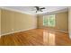 Bright bedroom featuring hardwood floors, a ceiling fan, neutral paint, and a window bringing in natural light at 5309 Ashley Trce, Atlanta, GA 30360