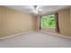 Carpeted bedroom with ceiling fan and window letting in lots of natural light at 5309 Ashley Trce, Atlanta, GA 30360