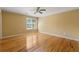 Bright bedroom featuring hardwood floors, a ceiling fan, neutral paint, and a window bringing in natural light at 5309 Ashley Trce, Atlanta, GA 30360