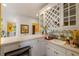 Butler's pantry featuring custom cabinetry, wine rack, sink, and ample counter space, great for entertaining at 5309 Ashley Trce, Atlanta, GA 30360