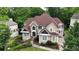 Stately two-story home featuring a stone façade, manicured landscaping, and a charming walkway to the front door at 5309 Ashley Trce, Atlanta, GA 30360