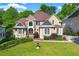 Stunning two-story home featuring a stone facade and manicured front lawn at 5309 Ashley Trce, Atlanta, GA 30360
