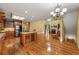 Open kitchen featuring wood cabinets, stainless steel appliances, granite countertops, and an island at 5309 Ashley Trce, Atlanta, GA 30360