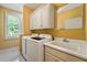 Bright laundry room with washer, dryer, utility sink, window and built-in cabinets at 5309 Ashley Trce, Atlanta, GA 30360