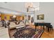 Elegant living room with hardwood floors, comfortable seating, piano, and view of the dining area at 5309 Ashley Trce, Atlanta, GA 30360