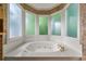 Close up of the luxurious bathroom soaking tub with frosted window detail at 5309 Ashley Trce, Atlanta, GA 30360