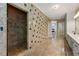 Expansive bathroom featuring a walk-in shower and tiled walls and floors at 5309 Ashley Trce, Atlanta, GA 30360