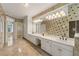 Bright and spacious bathroom with dual sinks, white cabinets, and large mirror at 5309 Ashley Trce, Atlanta, GA 30360