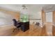 Office with hardwood floors, a large desk, decorative wallpaper, with a view to the foyer at 5309 Ashley Trce, Atlanta, GA 30360