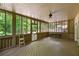 The screened porch features natural wood flooring, walls, and ceiling along with views of the backyard at 5309 Ashley Trce, Atlanta, GA 30360