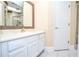 Well-lit bathroom with white vanity, updated fixtures, and tiled floor at 5697 Brooklyn Ln, Norcross, GA 30093