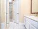 Bright bathroom with white tile, updated shower, and vanity with ample storage at 5697 Brooklyn Ln, Norcross, GA 30093
