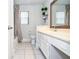 This bathroom features a single sink vanity with framed mirror and a shower with a curtain at 5697 Brooklyn Ln, Norcross, GA 30093