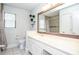 Charming bathroom with white cabinets, large mirror, and updated fixtures at 5697 Brooklyn Ln, Norcross, GA 30093