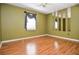 Spacious bedroom featuring wood floors, ample natural light, and neutral decor at 5697 Brooklyn Ln, Norcross, GA 30093