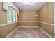 Cozy tan bedroom features travertine tile and natural light from a large window at 5697 Brooklyn Ln, Norcross, GA 30093