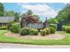 Brookfield community entrance with decorative stone pillars, manicured landscaping, and appealing signage at 5697 Brooklyn Ln, Norcross, GA 30093