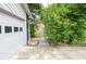Driveway and garage exterior featuring some partial garden view at 5697 Brooklyn Ln, Norcross, GA 30093