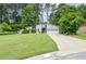 A modern home features a well-maintained front yard, driveway, and garage, offering an inviting curb appeal at 5697 Brooklyn Ln, Norcross, GA 30093