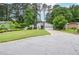 Gray home exterior with front lawn and mature trees, as seen from the street at 5697 Brooklyn Ln, Norcross, GA 30093