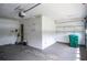 Spacious garage with ample storage space, including overhead shelving and utility area at 5697 Brooklyn Ln, Norcross, GA 30093