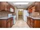 Galley kitchen features dark cabinets, granite counters, a mosaic backsplash and stainless steel appliances at 5697 Brooklyn Ln, Norcross, GA 30093