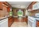 Kitchen includes tile backsplash, stainless appliances, and view of the yard and covered patio at 5697 Brooklyn Ln, Norcross, GA 30093