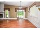 Spacious living room with wood flooring, a fireplace, and windows overlooking the backyard at 5697 Brooklyn Ln, Norcross, GA 30093
