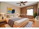 Comfortable main bedroom featuring a ceiling fan, neutral color palette, soft textures and decor at 5697 Brooklyn Ln, Norcross, GA 30093