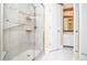 Modern shower featuring glass door, tiled walls, and convenient grab bar at 5697 Brooklyn Ln, Norcross, GA 30093