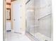 Updated shower with glass door, built-in seat, and decorative tile accents at 5697 Brooklyn Ln, Norcross, GA 30093