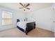 Well-lit bedroom with plush carpet, neutral walls, ceiling fan, and plenty of natural light at 8360 Village School Dr, Cumming, GA 30041