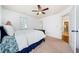 Bright bedroom features ceiling fan, carpet flooring, neutral walls, and ample natural light at 8360 Village School Dr, Cumming, GA 30041