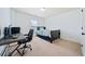 Cozy bedroom with plush carpet, neutral walls, desk, and ample workspace at 8360 Village School Dr, Cumming, GA 30041