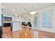 Open-concept design seamlessly connects dining area, kitchen, and inviting living room at 8360 Village School Dr, Cumming, GA 30041