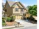 Charming home with manicured landscaping and a two-car garage, set in a neighborhood at 8360 Village School Dr, Cumming, GA 30041