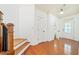 Bright foyer with hardwood floors, staircase with wood banister, and white trim at 8360 Village School Dr, Cumming, GA 30041