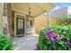 Charming front porch enhanced with colorful flowers and stone facade at 8360 Village School Dr, Cumming, GA 30041