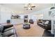 Open living room view showcasing seamless transition to the kitchen and dining area at 8360 Village School Dr, Cumming, GA 30041