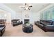 Spacious living room with a fireplace, large windows, and comfortable seating at 8360 Village School Dr, Cumming, GA 30041