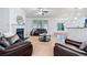 Comfortable living room featuring a fireplace, ceiling fan, and large windows at 8360 Village School Dr, Cumming, GA 30041